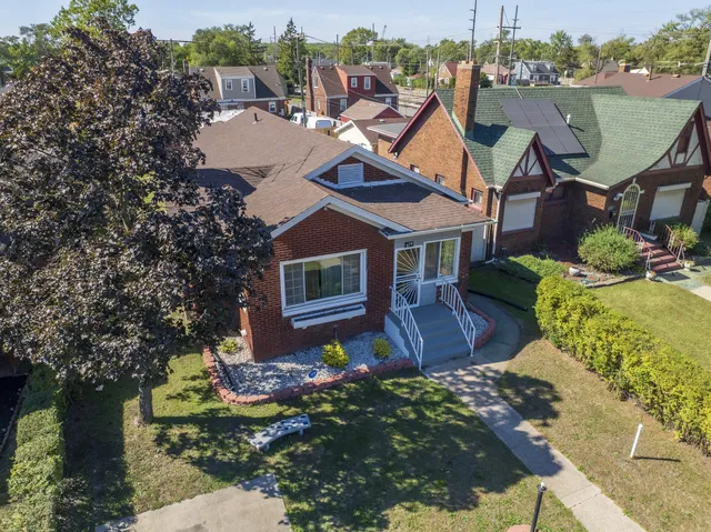 an aerial view of residential houses with yard