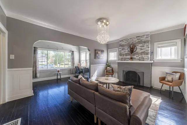a living room with furniture and a chandelier