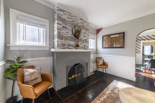 a living room with furniture and a fireplace