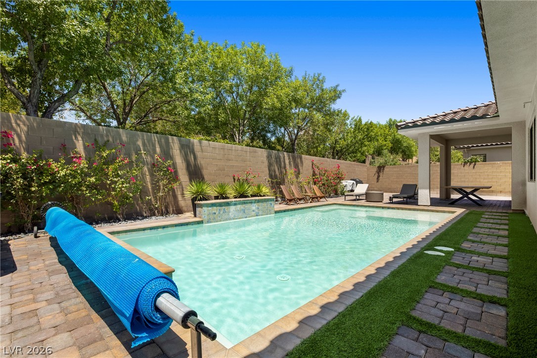 45 Garibaldi Way Henderson, NV 89011 - Photo 34 of 74 Lush landscaping and a sparkling swimming pool define this private outdoor oasis.