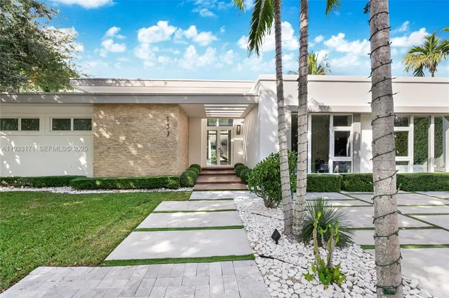 a front view of a house with garden