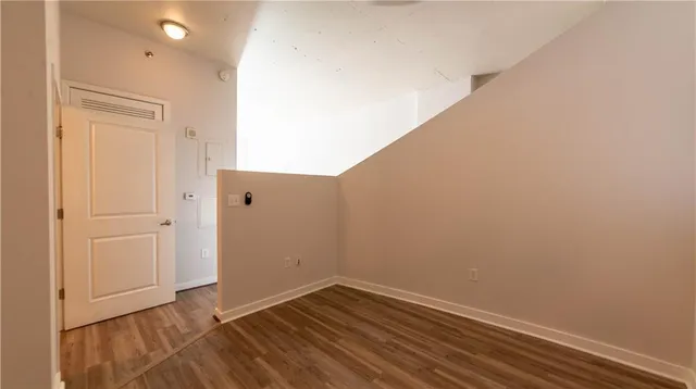 an empty room with wooden floor