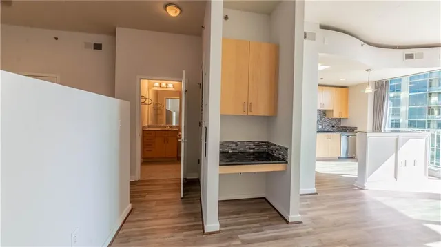 a kitchen with a refrigerator and a stove top oven