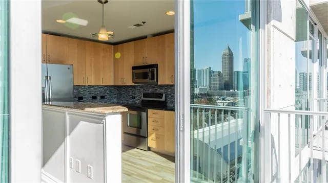 a kitchen with kitchen island granite countertop a refrigerator a stove a sink and a refrigerator