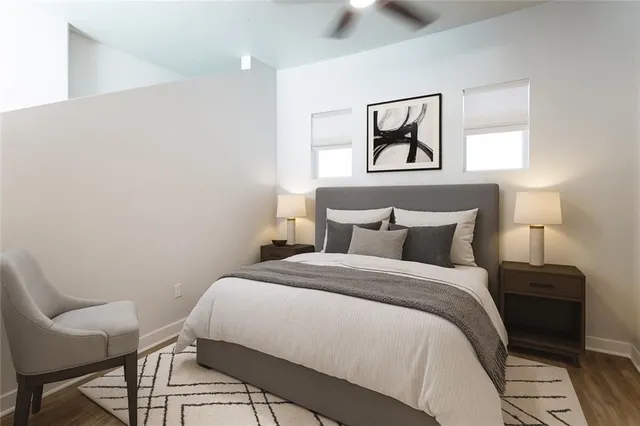 a bedroom with a bed and a painting on the wall