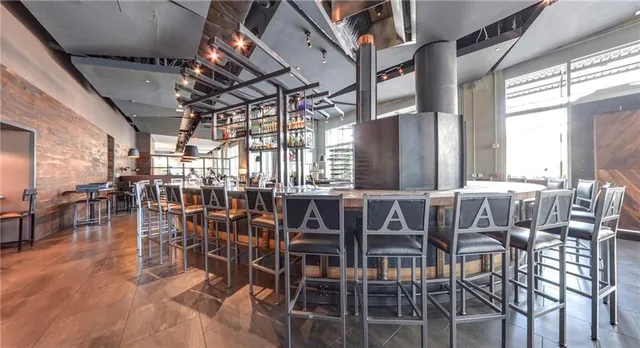 a room with lots of wooden furniture and windows