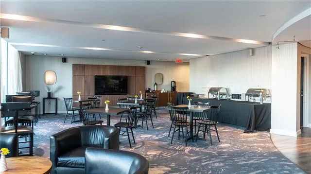 a living room with lots of furniture and view of kitchen