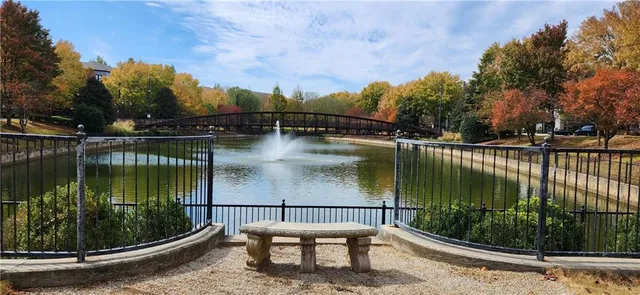 a view of a lake with a bench next to a lake