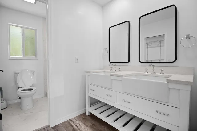 a bathroom with a toilet sink and mirror