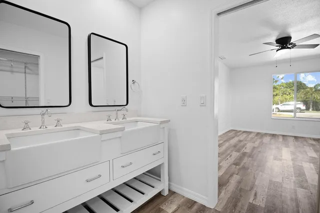 a bathroom with 2 sink and a mirror