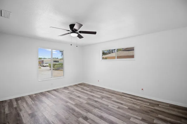 a view of empty room with ceiling fan