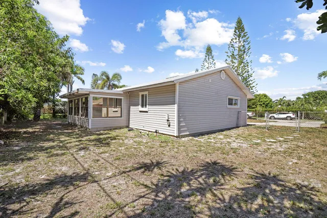 a view of a house with a yard and garage