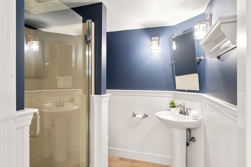 20 Island Creek Road Duxbury, MA 02332 - Photo 29 of 42 a bathroom with a sink a mirror and a shower