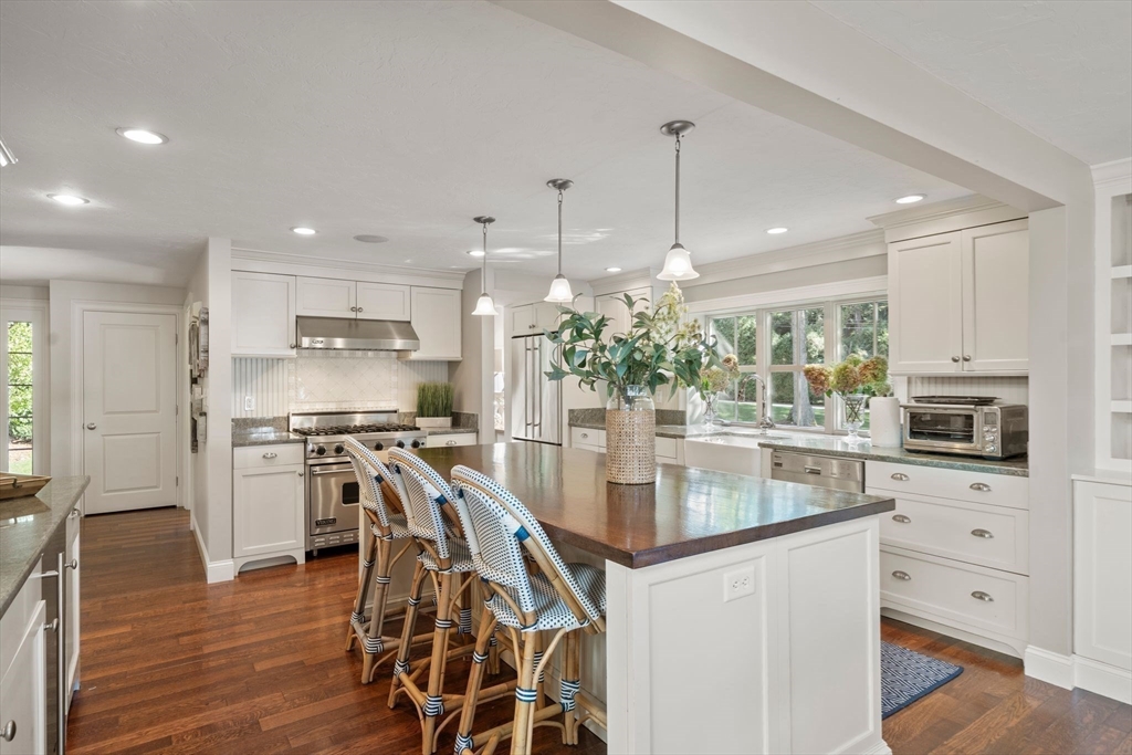 20 Island Creek Road Duxbury, MA 02332 - Photo 7 of 42 a kitchen with stainless steel appliances kitchen island granite countertop a stove top oven a sink a counter space and cabinets