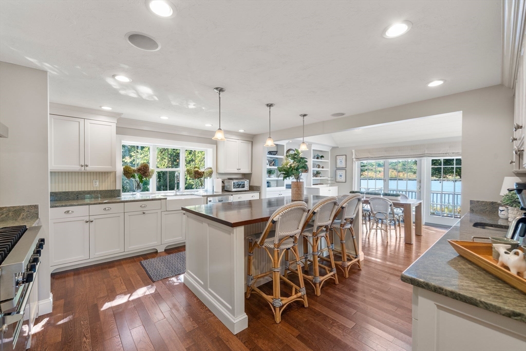 20 Island Creek Road Duxbury, MA 02332 - Photo 8 of 42 a kitchen with lots of wooden furniture dining table and stainless steel appliances