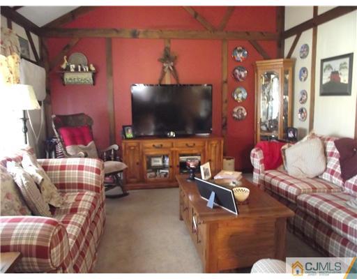 11 Sims Road Edison, NJ 08817 - Photo 3 of 13 a living room with furniture and a flat screen tv