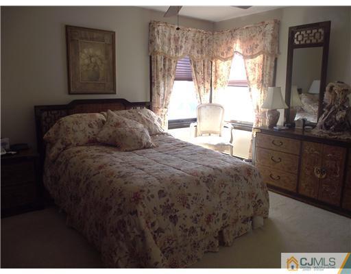 11 Sims Road Edison, NJ 08817 - Photo 8 of 13 a bedroom with a bed and dresser with mirror