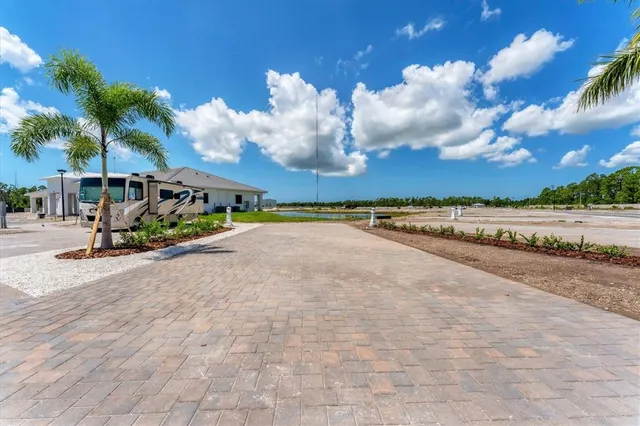 a view of a house with a yard and lake view