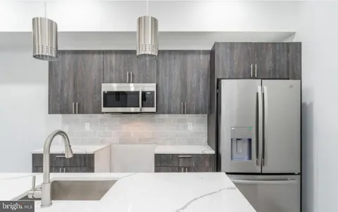 a kitchen with stainless steel appliances a refrigerator and sink