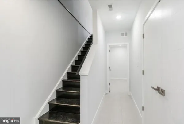 wooden floor in an empty room with a staircase