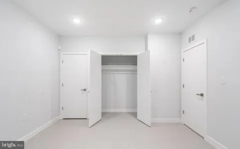 an empty room with closet area