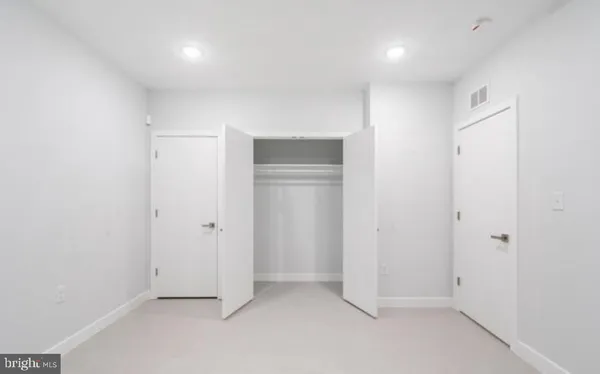 an empty room with closet area