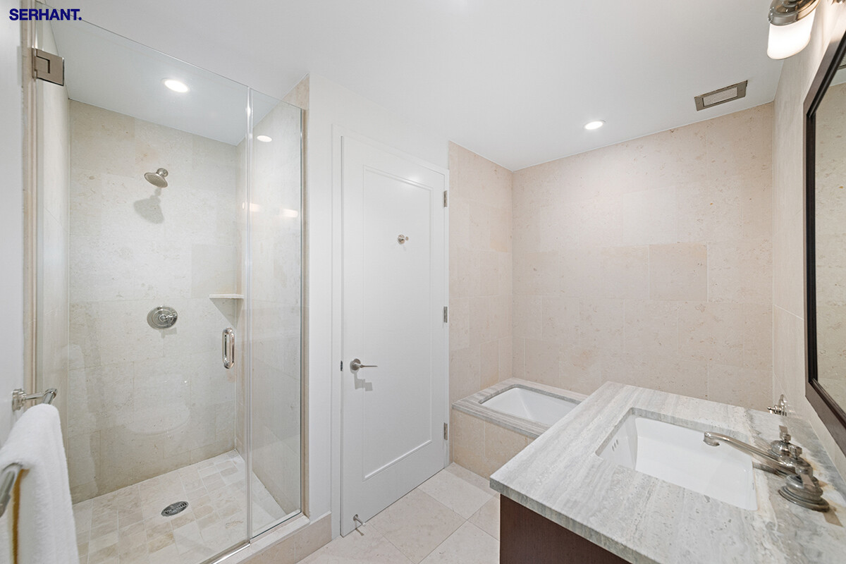 100 Riverside Boulevard, Unit 25D Manhattan, NY 10069 - Photo 10 of 21 a bathroom with a granite countertop sink a shower and mirror