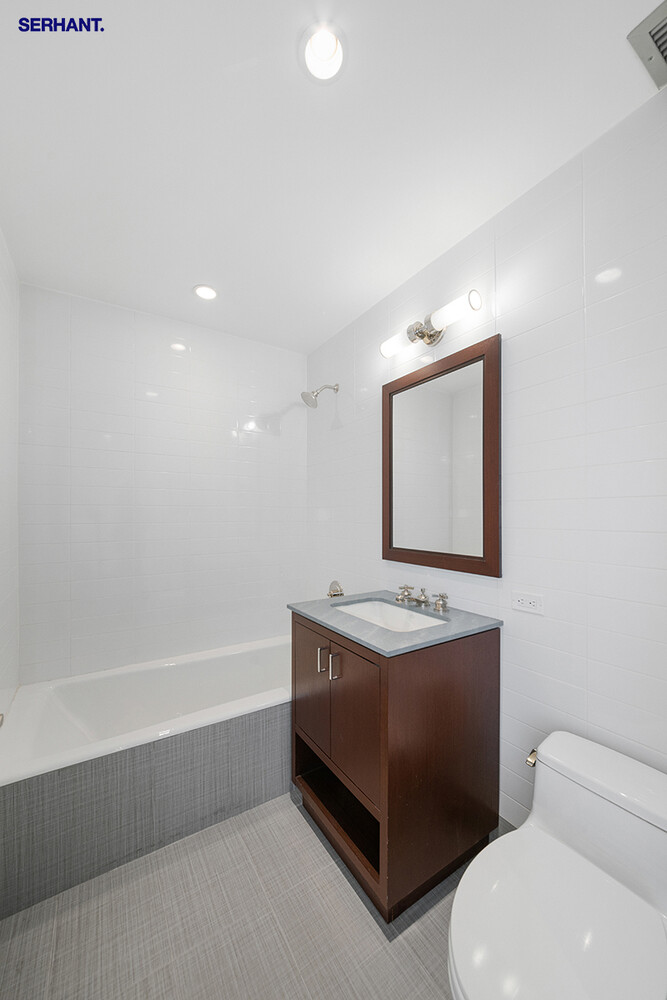 100 Riverside Boulevard, Unit 25D Manhattan, NY 10069 - Photo 13 of 21 a bathroom with a toilet sink and mirror