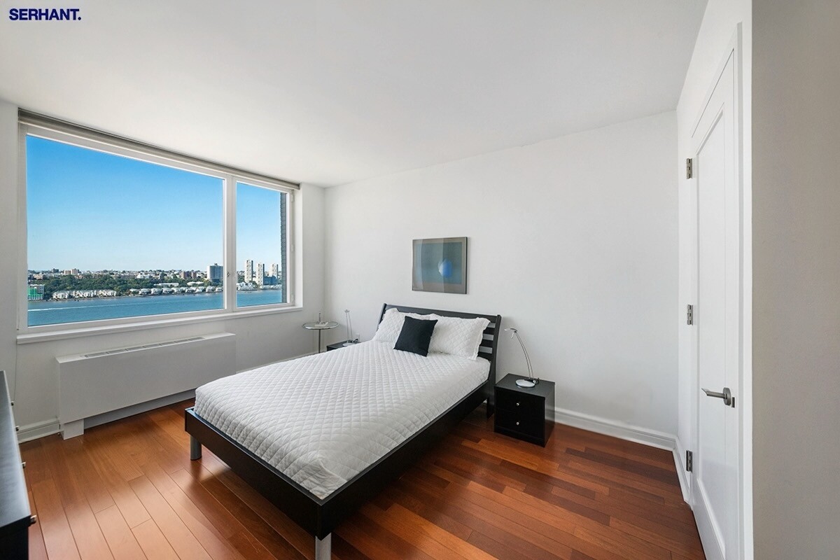 100 Riverside Boulevard, Unit 25D Manhattan, NY 10069 - Photo 8 of 21 a bedroom with a bed and window