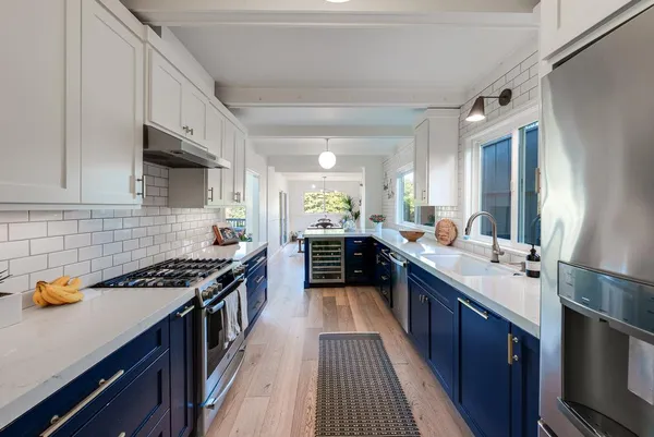 a kitchen with stainless steel appliances a sink stove and cabinets
