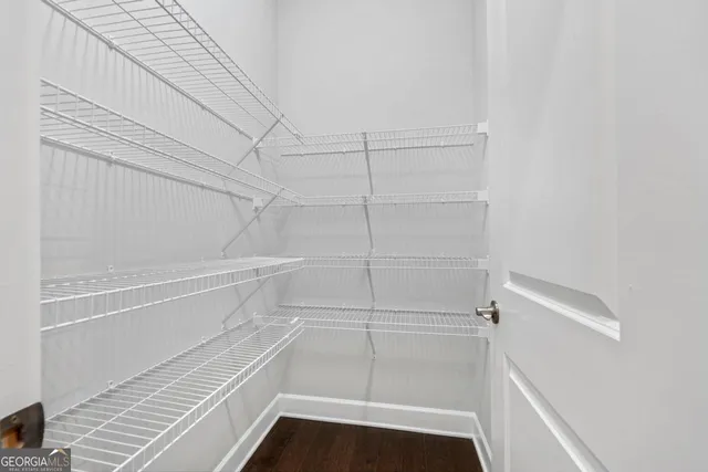 a walk in closet with empty racks