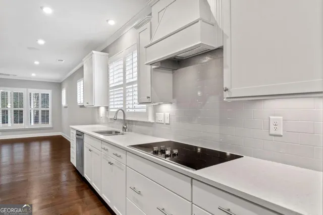 a kitchen with a sink a stove and cabinets