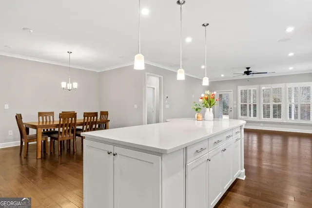 an open kitchen with a table and chairs