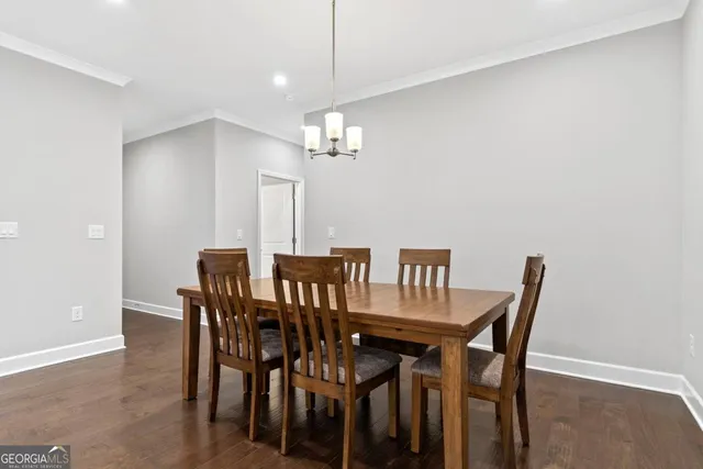 a view of a dining room with furniture and chandelier
