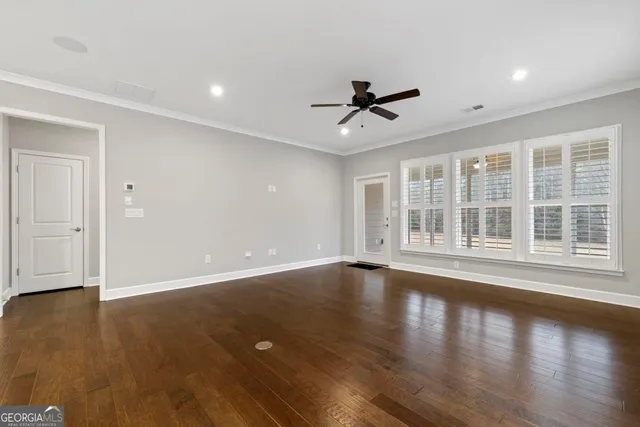 a view of a work space with a window and wooden floor