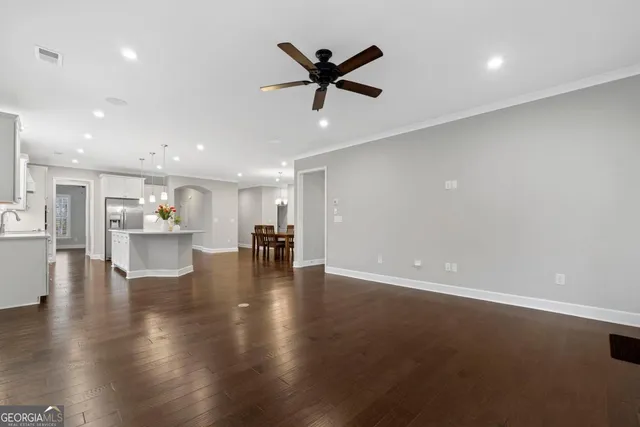 a view of empty room with wooden floor and windows