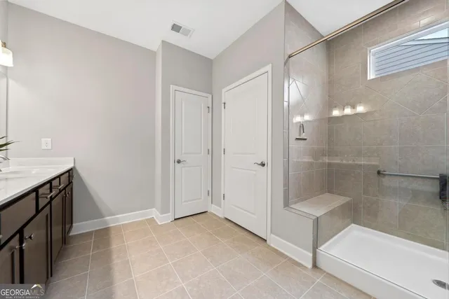 a bathroom with a glass shower door