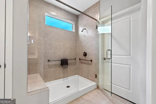 a view of a bedroom with a bed and balcony