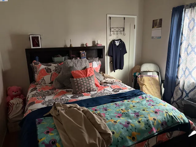 a bed sitting in a bedroom next to a window