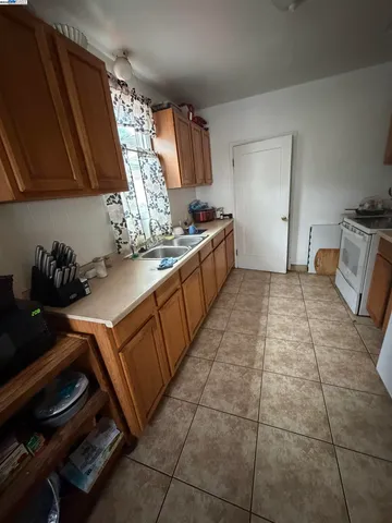 a kitchen with a sink a stove and cabinets