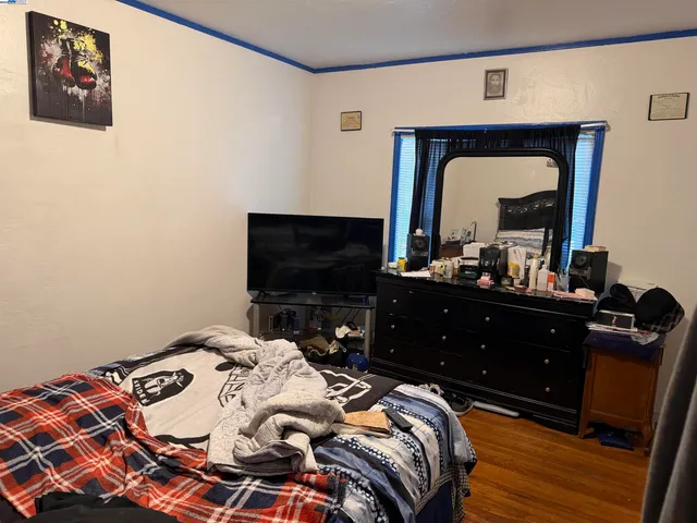 a bedroom with a bed and a mirror