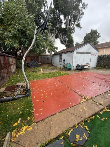 a backyard of a house with barbeque oven