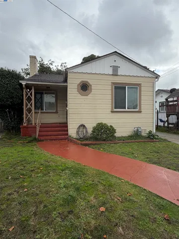 a front view of house with yard and outdoor seating