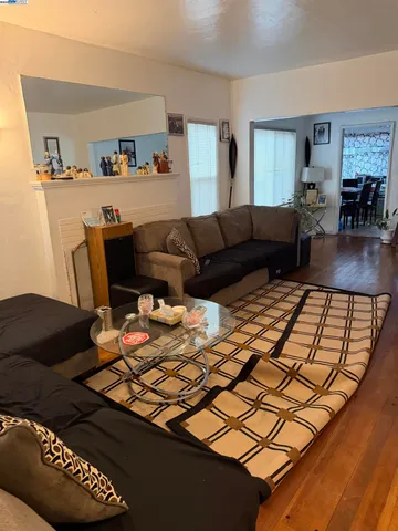 a living room with furniture rug and lamp