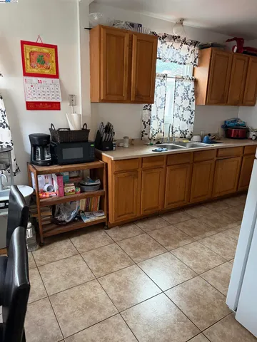 a kitchen with stainless steel appliances a stove a sink and a refrigerator