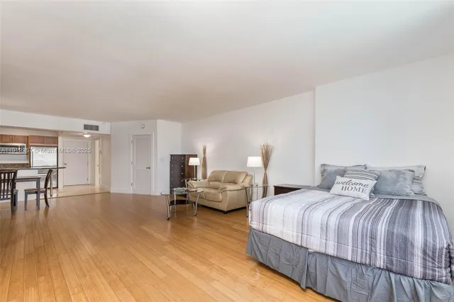 a bedroom with double bed and a table