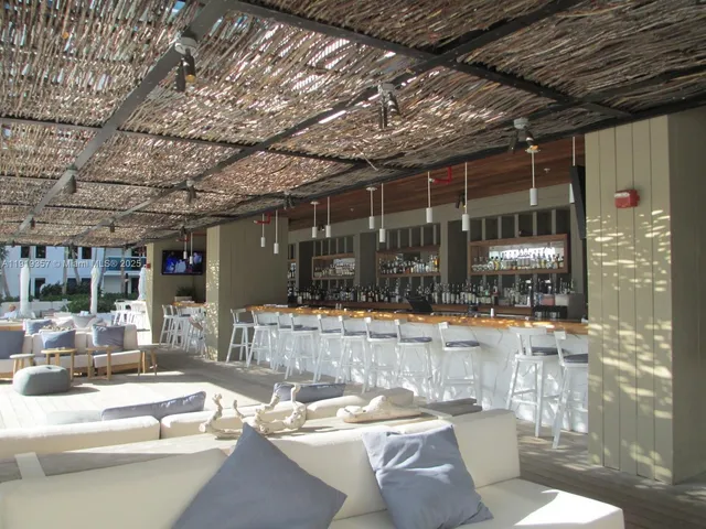 a view of a patio with table and chairs and potted plants