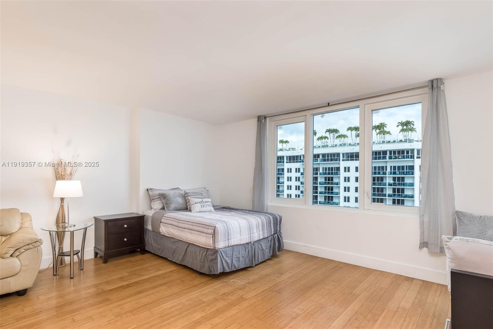 2301 Collins Avenue, Unit 1512 Miami Beach, FL 33139 - Photo 8 of 34 a bedroom with a bed and a large window