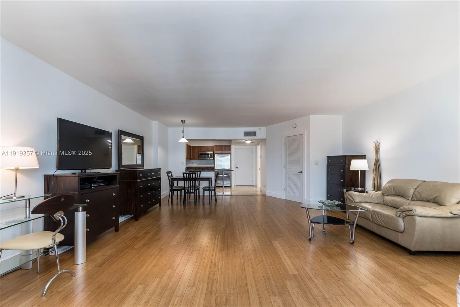2301 Collins Avenue, Unit 1512 Miami Beach, FL 33139 - Photo 9 of 34 a living room with furniture and a flat screen tv
