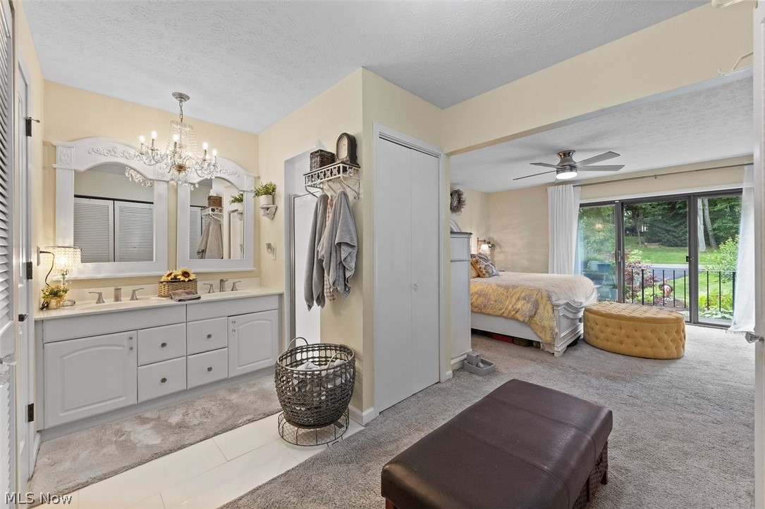 171 Granger Road, Unit 107 Medina, OH 44256 - Photo 25 of 41 Master bathroom with double sinks, a shower and toilet with plenty of closets for clothes and closets for storage